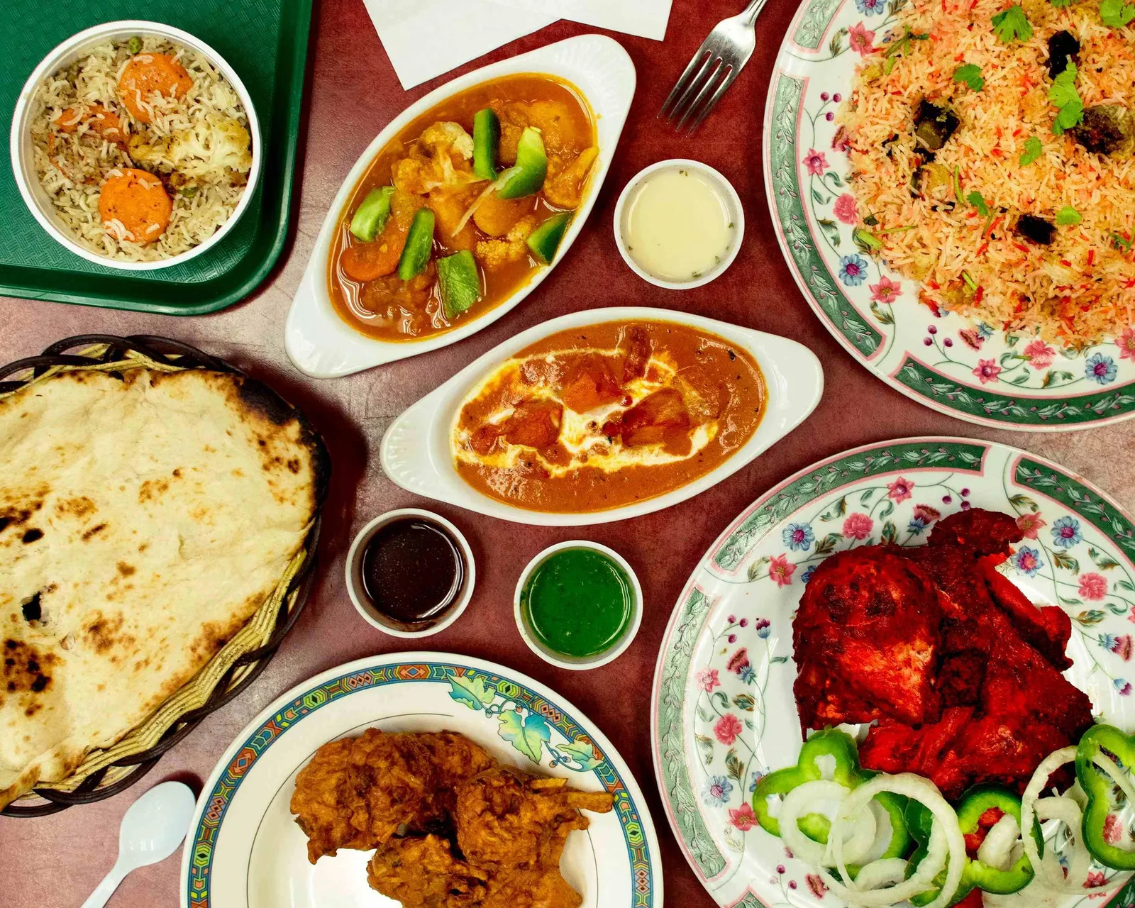 Biryani, butter chicken, tandoori chicken, naan and chutneys